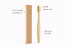 Bamboo toothbrush with eco-friendly kraft paper packaging on a white background
