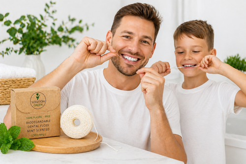 Man and child with eco-friendly dental floss and packaging on a table.