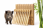 Bamboo toothbrushes with packaging and a wild boar in the background