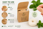 Biodegradable dental floss with packaging and mint leaves on a white background