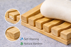 Bamboo soap dish with soap bars and close-up details on a gray surface