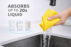 Yellow towel absorbing water from a faucet with text indicating absorption capacity.