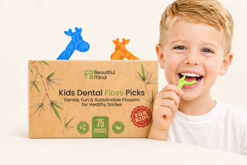 Child holding a dental floss pick with a box of Beautiful Mind Kids Dental Floss Picks in the background.