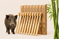 Bamboo toothbrushes with packaging and a piglet on a beige background