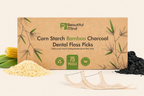 Box of Beautiful Mind corn starch bamboo charcoal dental floss picks with floss and ingredients on a beige background