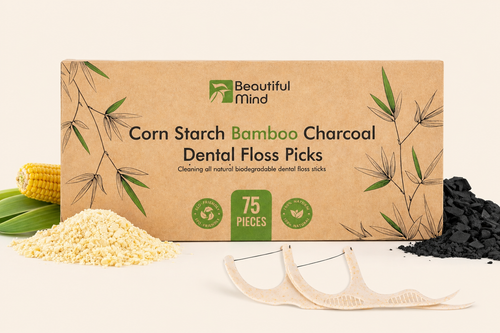 Box of Beautiful Mind corn starch bamboo charcoal dental floss picks with floss and ingredients on a beige background